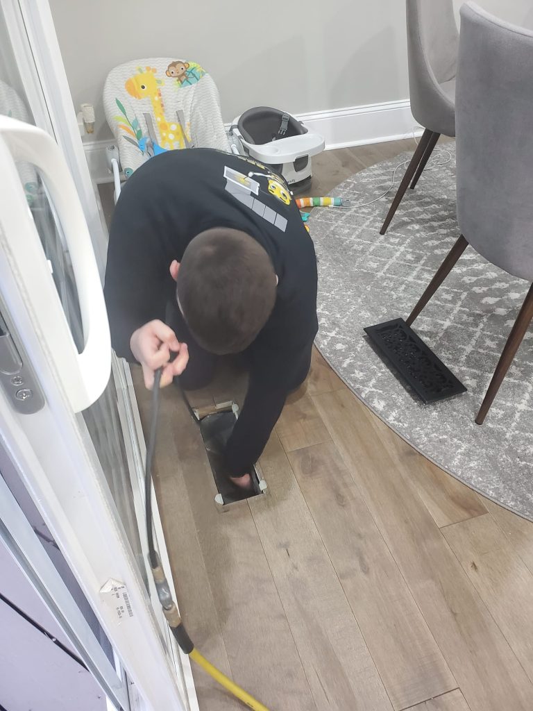 Bee cleaning technician is cleaning air ducts and equipment